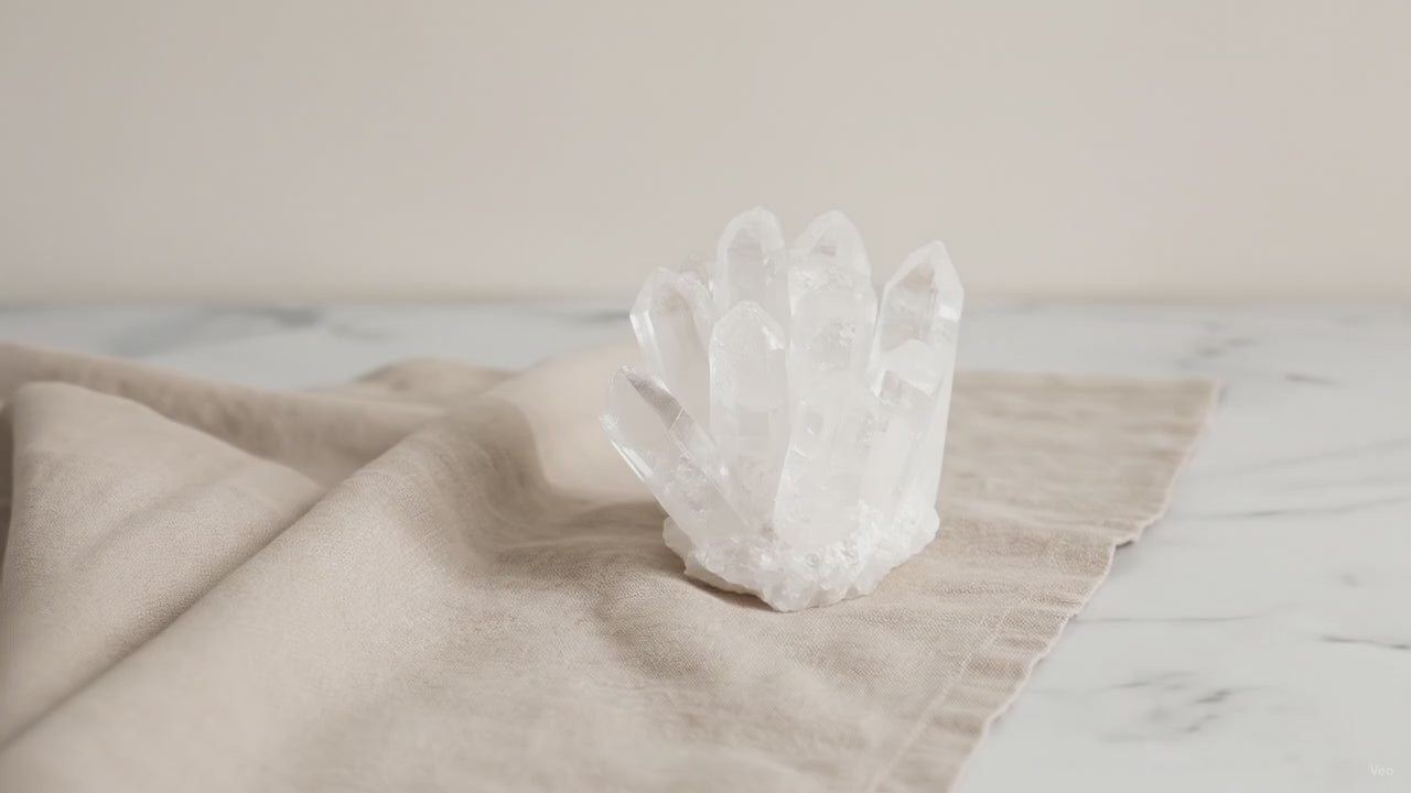 Crafted clear quartz crystal cluster on natural linen
