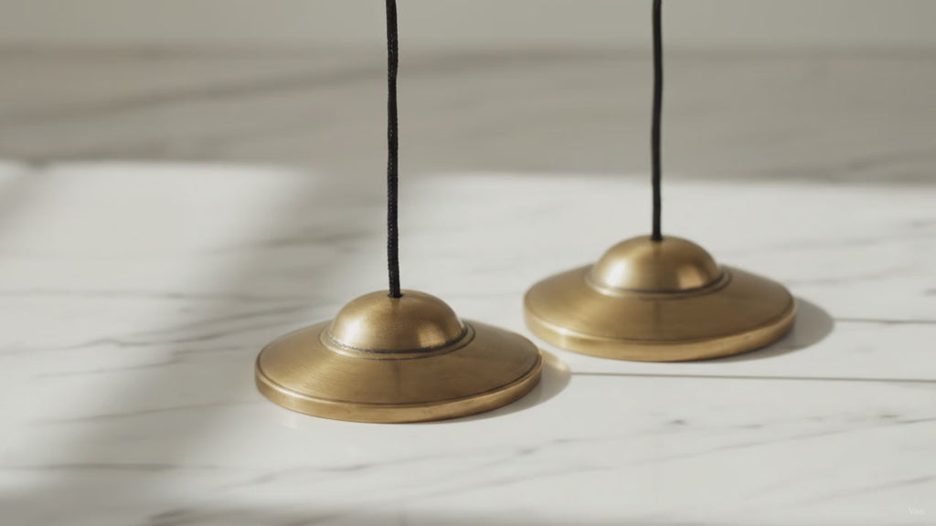 Plain brass Tibetan tingsha cymbals, premium weight, slow close-up
