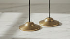 Plain brass Tibetan tingsha cymbals, premium weight, slow close-up