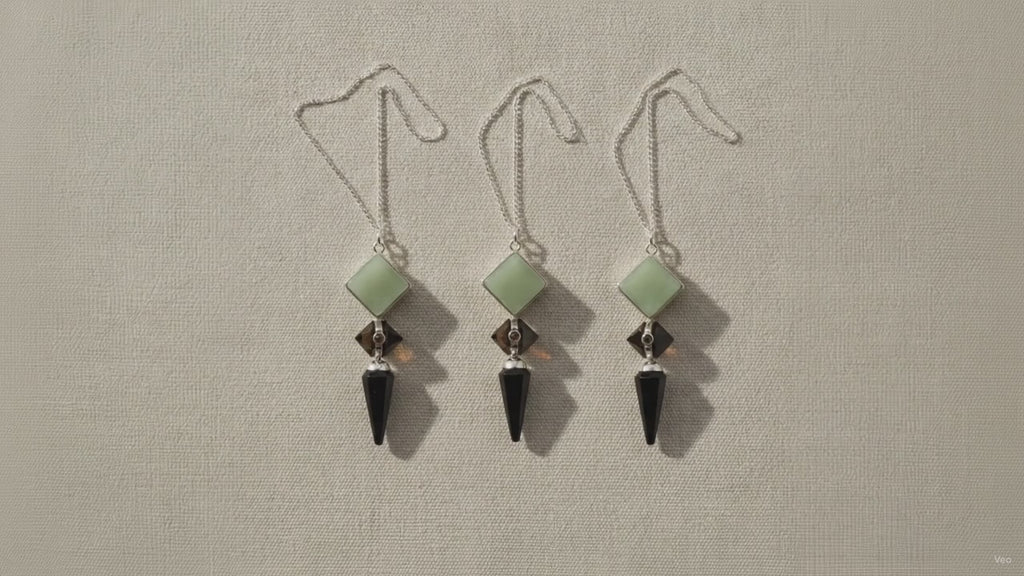 Three pendulums in green aventurine, tiger eye and black agate hanging side by side video