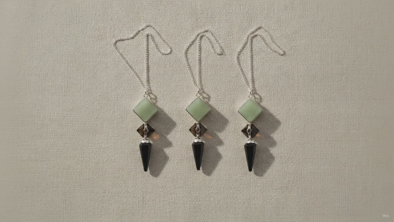 Three pendulums in green aventurine, tiger eye and black agate hanging side by side video