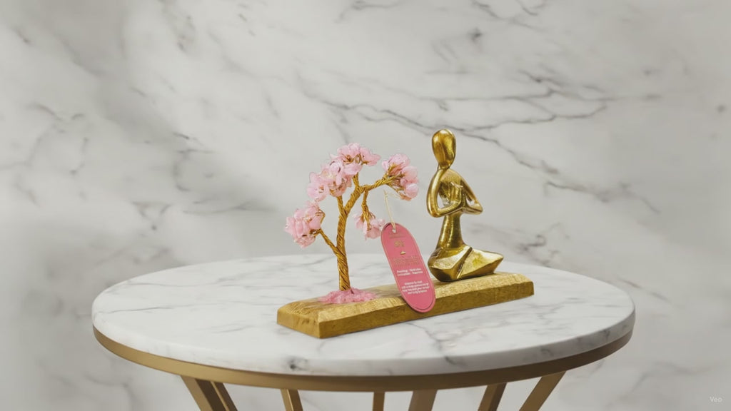 Rose quartz gemstone yoga garden with brass namaste figure, slow product video