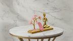 Rose quartz gemstone yoga garden with brass namaste figure, slow product video