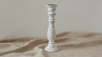 Whitewash mango wood pillar candle holder on natural linen