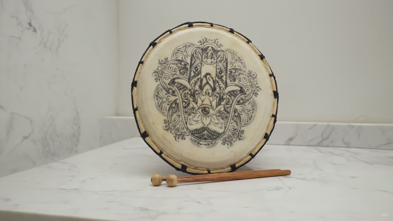 Hamsa shamanic frame drum 30cm on a stand with two beaters on marble, slow camera push-in