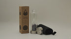 Amethyst chips crystal water bottle with its box, lid and padded sleeve, soft light moving across the wall