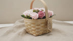 Pink and blush soap roses in a woven wicker basket with a tag, on rumpled linen video
