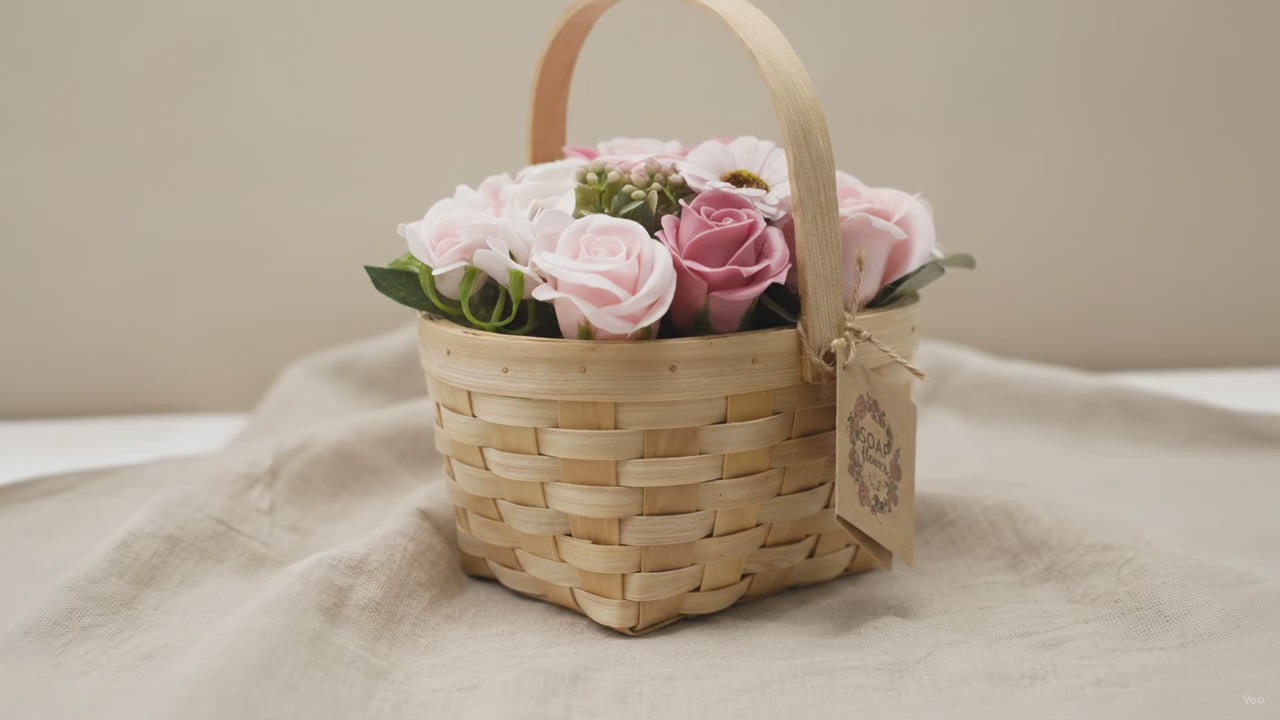 Pink and blush soap roses in a woven wicker basket with a tag, on rumpled linen video