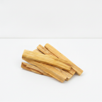First grade palo santo wood sticks on a clean white surface against a white wall
