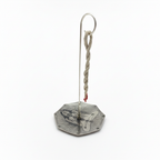 Rope incense hanging from the hook stand over the engraved silver plated dish