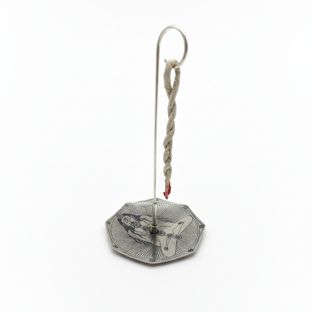 Rope incense hanging from the hook stand over the engraved silver plated dish