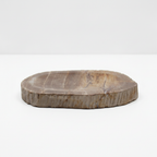 Petrified wood soap dish on a clean white surface against a white wall