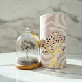 Pyrite gemstone dome garden on a marble table with a marble wall behind
