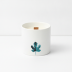 Set of 3 marsh viola botanical candles on a clean white surface against a white wall