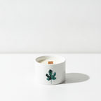 Set of 3 mulberry harvest botanical candles on a clean white surface against a white wall