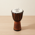 Medium Soul Sound djembe drum standing on a pale wooden floor against a white wall