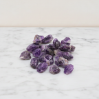 A spread of rough amethyst chunks in deep purple on cotton canvas - view 2