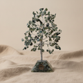 Moss agate chipstone tree on a speckled orgonite base, on rumpled linen