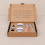 Dark self-care kit box lying flat and closed on rumpled linen