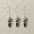 Three pendulums in green aventurine, tiger eye and black agate hanging side by side