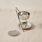 Plated brass incense warmer with mesh dish and tealight tray, on rumpled linen