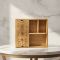 Four section mango wood tarot box with an engraved card holder lid, on a white marble table