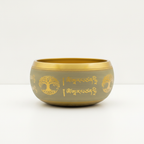 Side of the aluminium singing bowl, engraved with a Tree of Life and Tibetan script