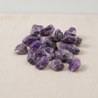 A spread of rough amethyst chunks in deep purple on cotton canvas - view 3