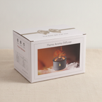 White volcano flame aroma diffuser with a textured dark lid, on cotton canvas - view 6