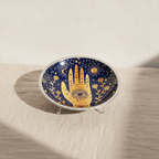 Midnight blue enamelled dish with a golden hamsa hand, standing on three legs - view 6