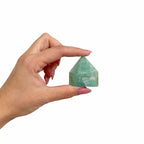 A polished green amazonite crystal point standing on cotton canvas - view 9