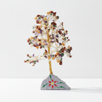 Large multi gemstone crystal tree on a white surface