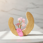 Rose quartz tree in a mango wood ring on a marble table
