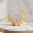Rose quartz gemstone tree framed by its wooden ring, marble background