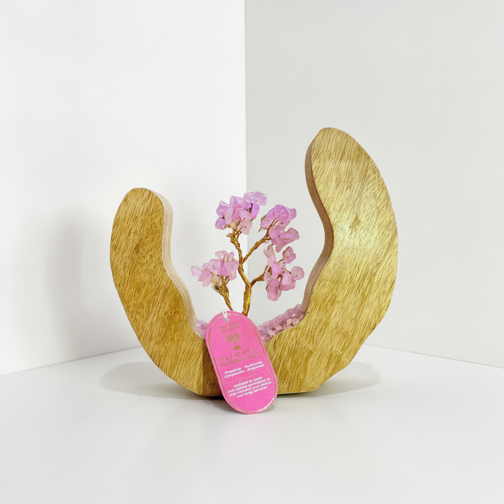Rose quartz tree in a mango wood ring on a white surface