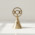 Triple moon brass altar bell on a marble worktop