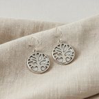 Tree of Life silver drop earrings with mother of pearl, on natural linen