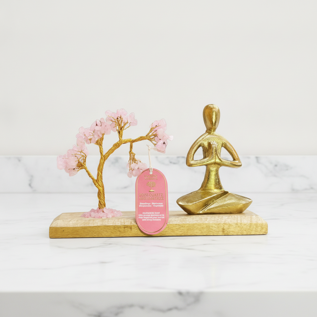 Rose quartz tree with namaste yoga figure on marble