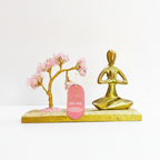 Rose quartz tree with namaste yoga figure on white